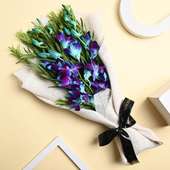 Three Blue Orchids With White Jute Packing And Fa Black Ribbon