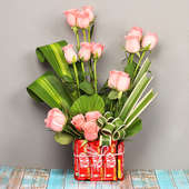 Arrangement of Roses with Chocolates in a Glass Vase