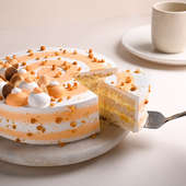 Eggless Butterscotch Cake Online - Sliced View of Cake with Knife