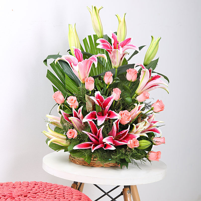 An arrangement of 4 Pink Lilies and 12 Pink Roses