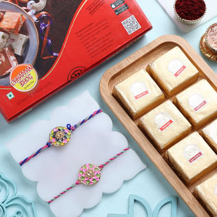 Set Of Two Floral Motif Rakhis With Nutty Sweets