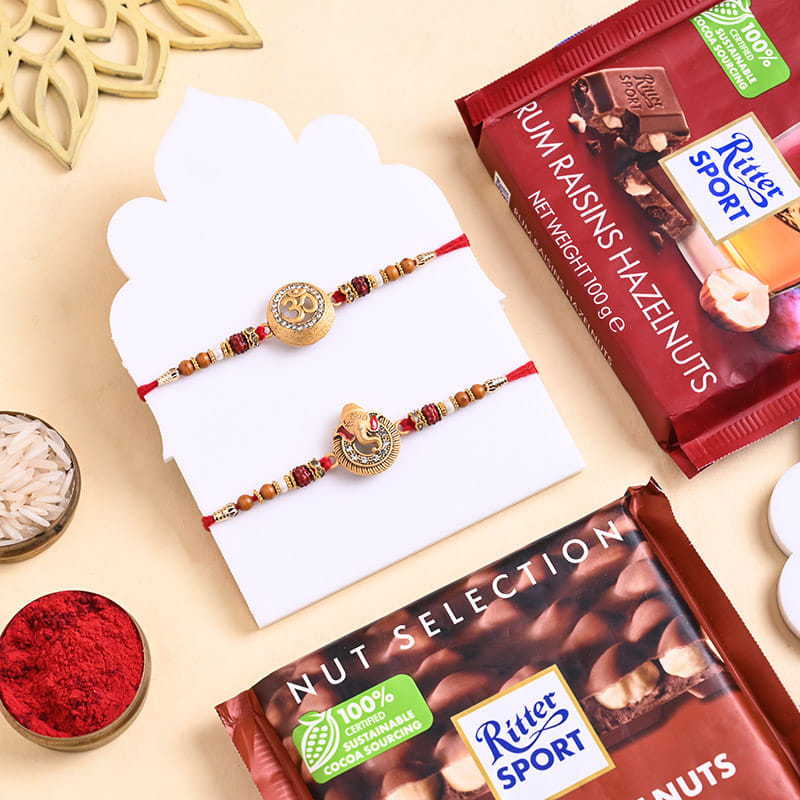 Two Auspicious Golden Rakhis With Nuts N Chocolate