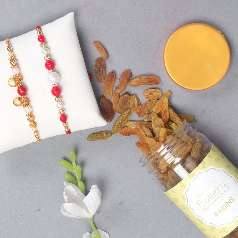Bead Rakhi N Resins Combo - Set of 2 Designer Rakhi with Complimentary Roli and Chawal and 100gm Raisins in Colorful Floweraura Container