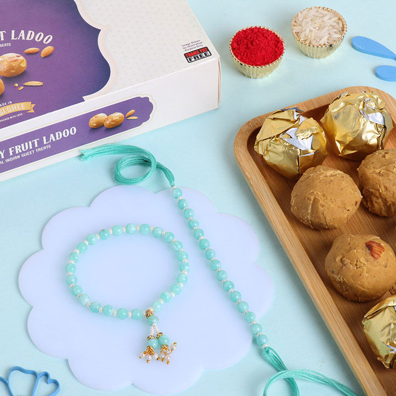 Send Blue Beaded Rakhi Set With Chana Dry Fruit Laddoo to UAE