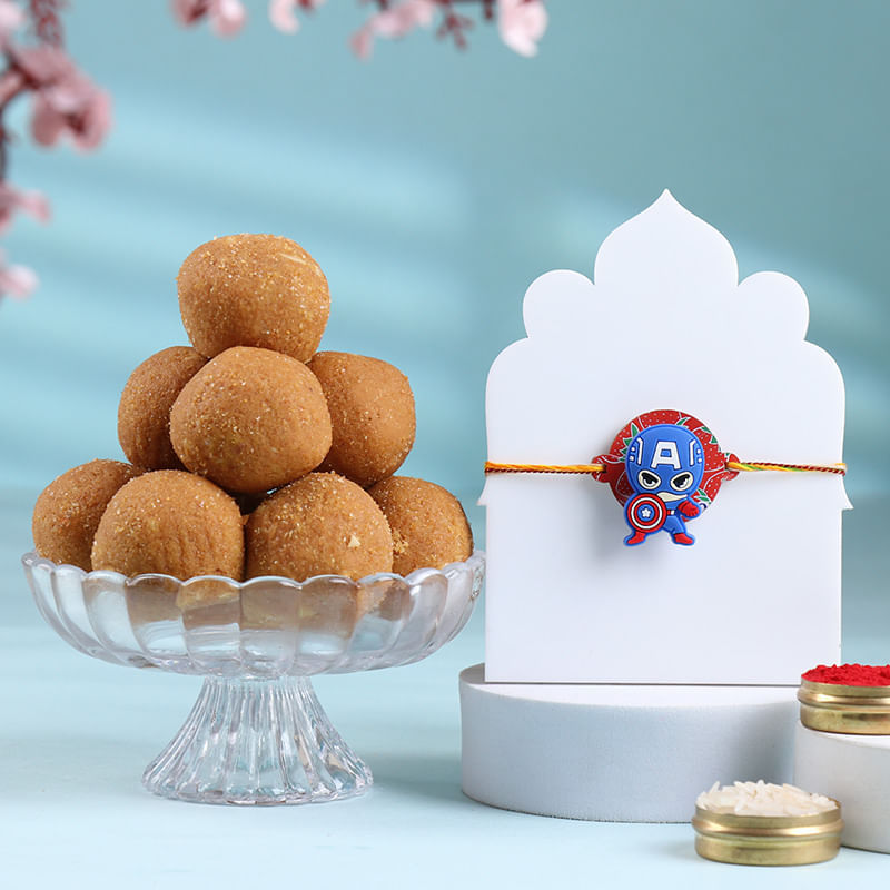 Let your little Avenger fan celebrate Raksha Bandhan in style! This quirky Captain America Rakhi features a bold, shielded design and vibrant colours, making it the perfect and wrist-worthy for your young superhero. Along with a box of rich, melt-in-your-mouth Besan Ladoos, this combo is all about action and affection. Buy this Avengers Rakhi online for your brother who loves Marvel. This Rakhi set combines power and sweetness in one unforgettable package.
