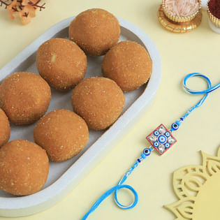Charming Evil Eye Rakhi With Besan Ladoos