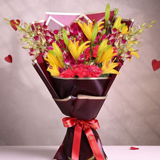 Charming Mixed Flowers In A Vase - Premium Bouquet of 12 Flowers with 6 Red Carnations and 2 Yellow Lilies and 4 Pink Orchids