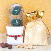 Choco Nut Rakhi Hamper - One Pearl Rakhi with Complimentary Roli and Chawal and 100gm Choco Cashews in Metallic Container and 100gm Cashews and One Potli