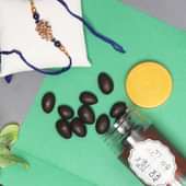 Chocofill Rakhi Combo - One Peacock Rakhi with Complimentary Roli and Chawal and 100gm Choco Almonds in Metallic Container