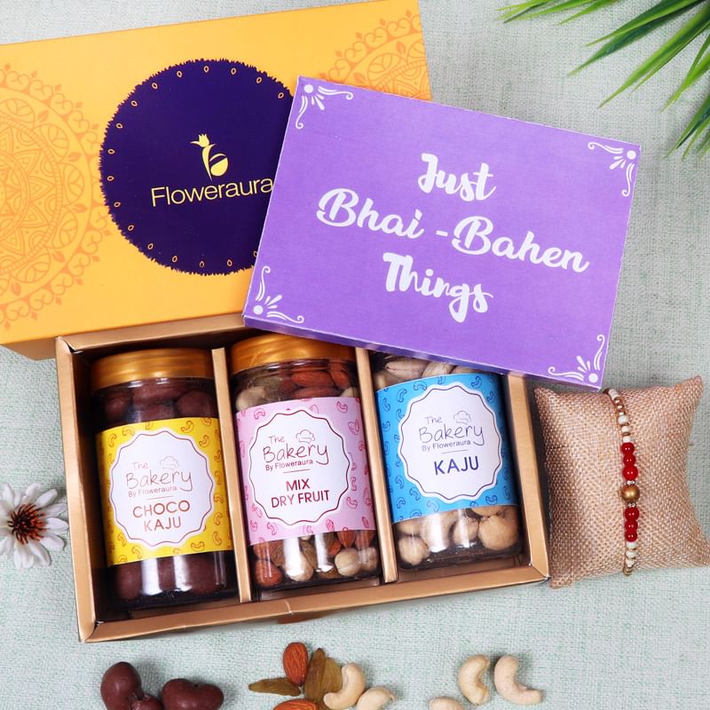 Chocolicious Dry Fruits N Rakhi Hamper - One Pearl Rakhi with Roli and Chawal and Mixed Dry Fruits and Cashews and Choco Cashews and One Floweraura Signature Box