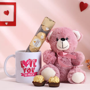 Pink 6-inch teddy, 4 Ferrero Rochers, white ceramic mug, and gift hamper box.