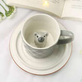 Cup & Saucer With A Bear On Top