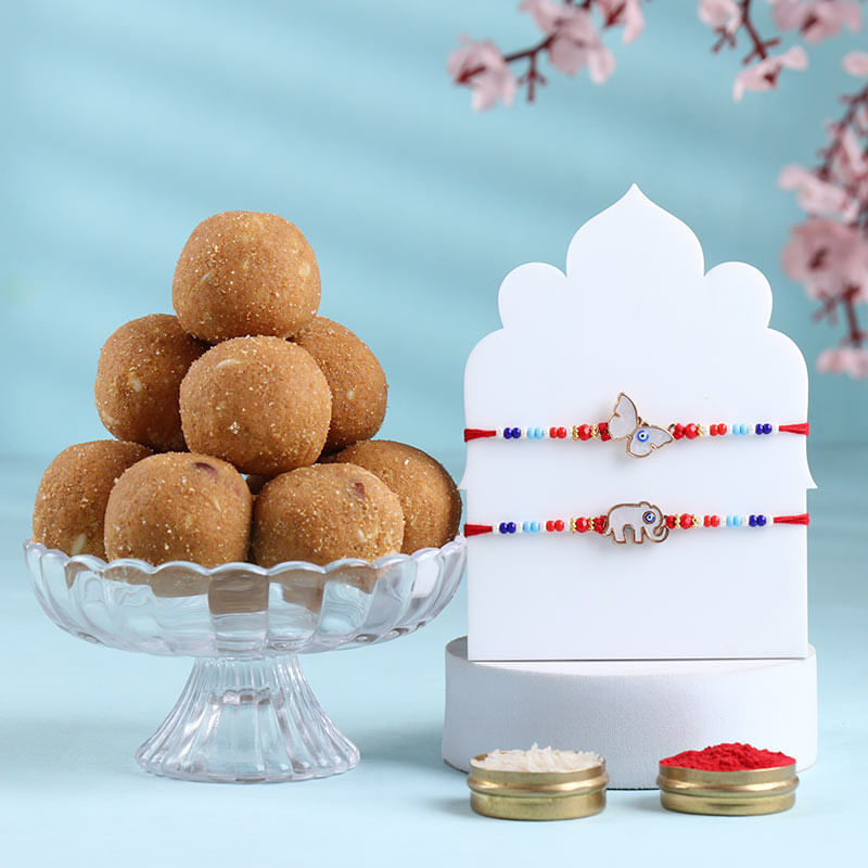 Cute Charms Beaded Rakhi Duo With Besan Ladoos