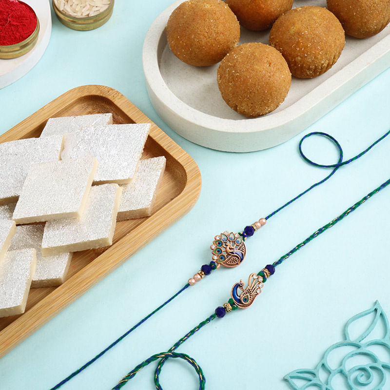 Dazzling Peacock Rakhi Duo With Sweets