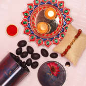 Delightful Rakhi Combo - One Rudraksh Rakhi with Complimentary Roli and Chawal and 100gm Choco Almonds in Metallic Container and One Designer Thali