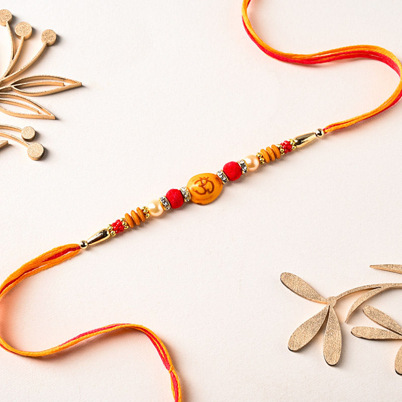Divine Om Charm Bracelet Rakhi With Fusion Sweets