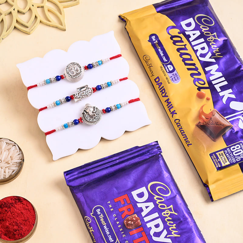 Three Divine Silver Rakhis With Cadbury Bars