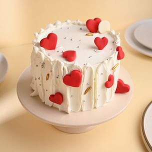 Round Cream Cake with Heart-Shaped Red Velvet Cake on Top