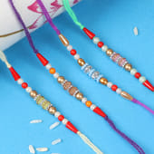Elegant Colored Rakhi Set - Set of 4 Attractive Designer Rakhis with Complimentary Roli and Chawal