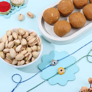 Elegant Evil Eye Rakhis With Besan Laddoo N Pista