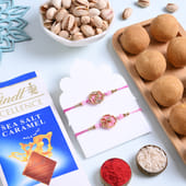 Elegant Floral Rakhi Duo With Sweets N Nuts