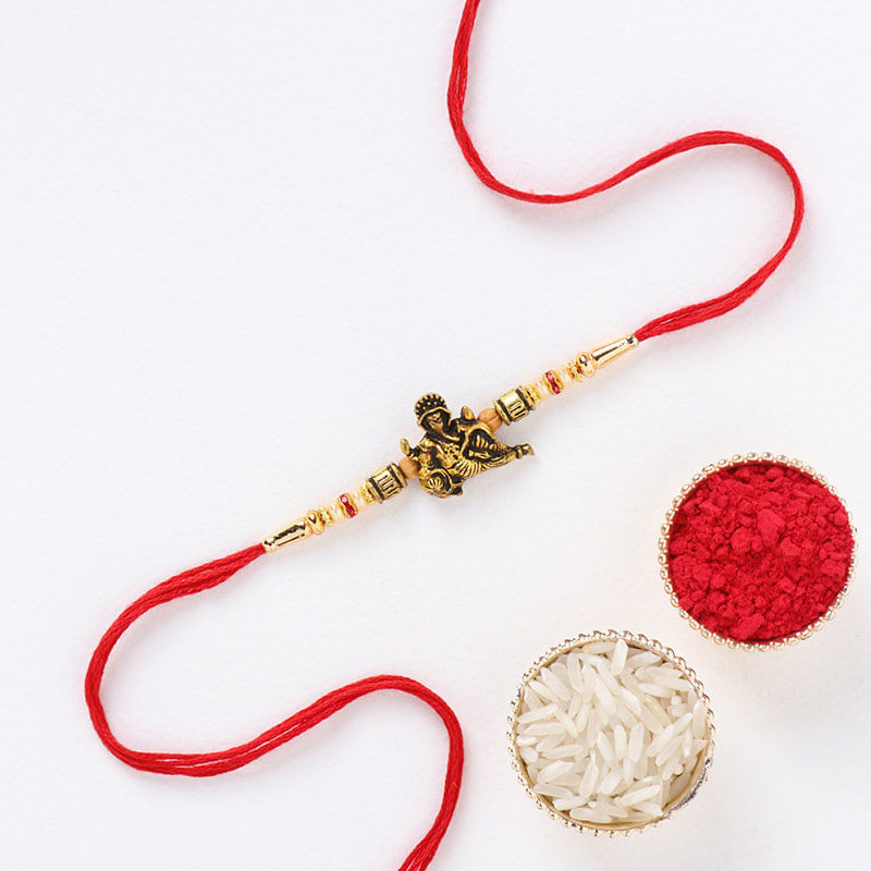 Elegant Idol Ganesha Metal Rakhi with Roli Chawal