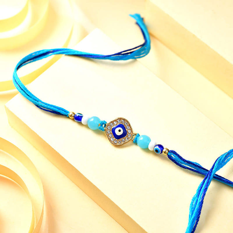 Evil Eye Rakhi With Orange Bites