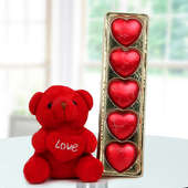 A tiny 3 inches teddy bear with a heart and a pack of heart shaped handmade chocolates