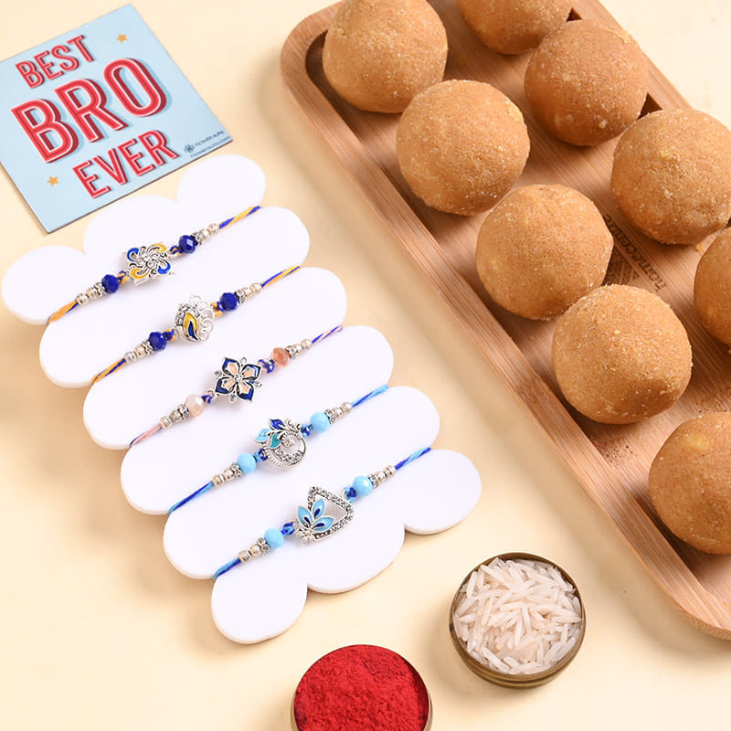 Five Blue N Silver Floral Rakhis With Besan Ladoos