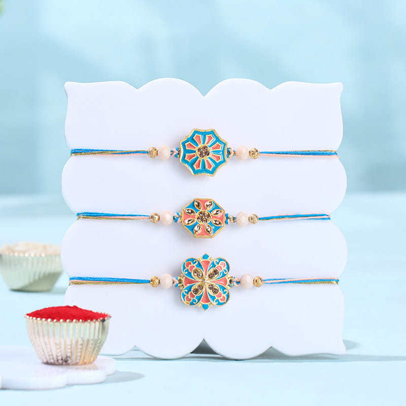 Floral Pastel Rakhi Trio With Besan Ladoos