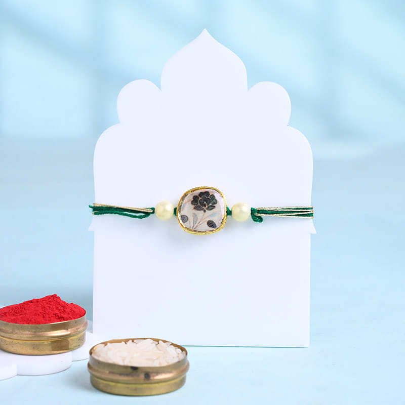 Floral Pearl Rakhi With Besan Ladoos