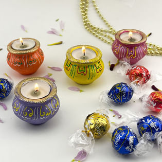 Four Matki Diyas And Assorted Chocolates