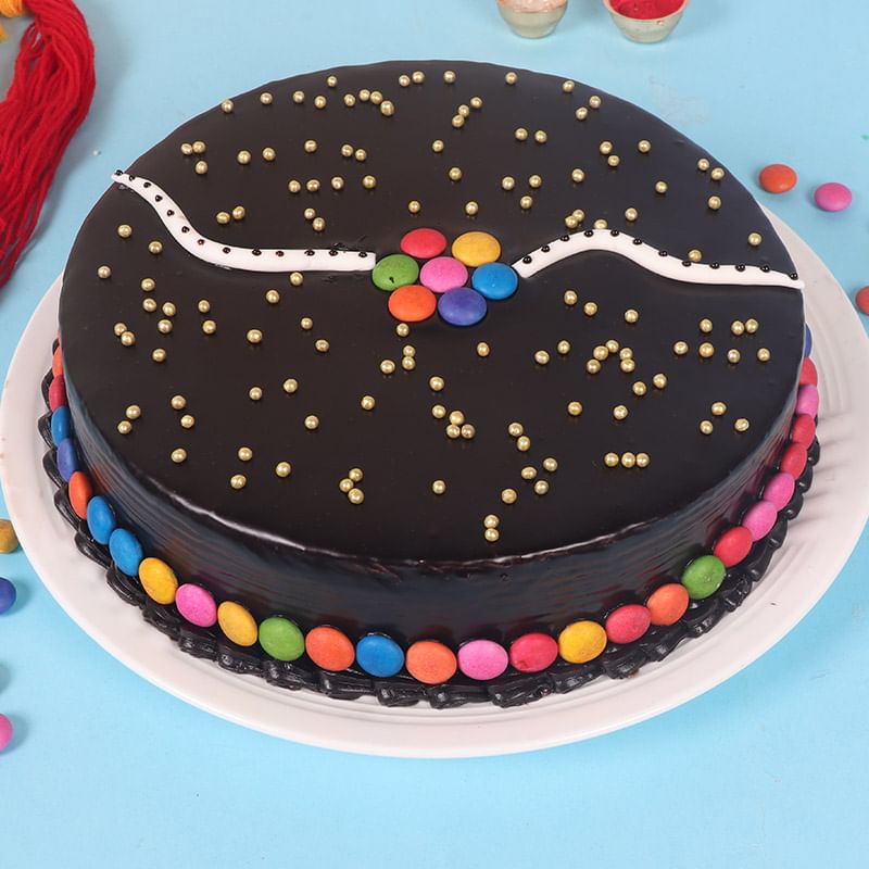 Side View of Choco Gems Cake Rakhi Duo Combo