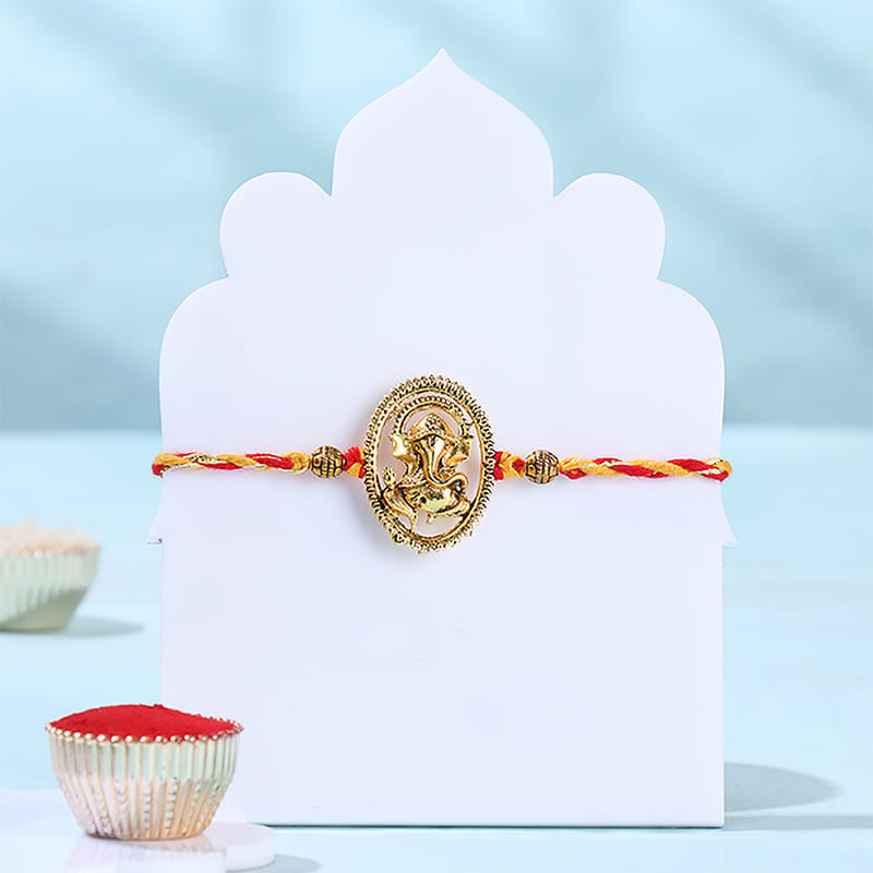Gold Toned Ganesha Rakhi With Bournville Chocolate