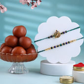 Golden Accents Peacock Rakhi Duo With Gulab Jamun