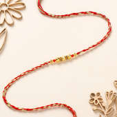 Golden Bead and Pearl Thread Rakhi