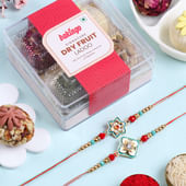 Graceful Floral Rakhi Duo With Ladoos