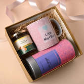 front view of Healthful hamper with ceramic mug, one Blossom Tea Tulsi Ginger, and honey.