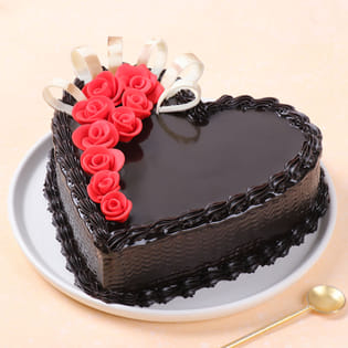 Heart shaped chocolate cake with red fondant roses on the top
