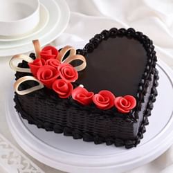 Heart shaped chocolate cake with red fondant roses on the top