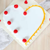 Heart Shaped Vanilla Cake With Cherries On Top - Top View