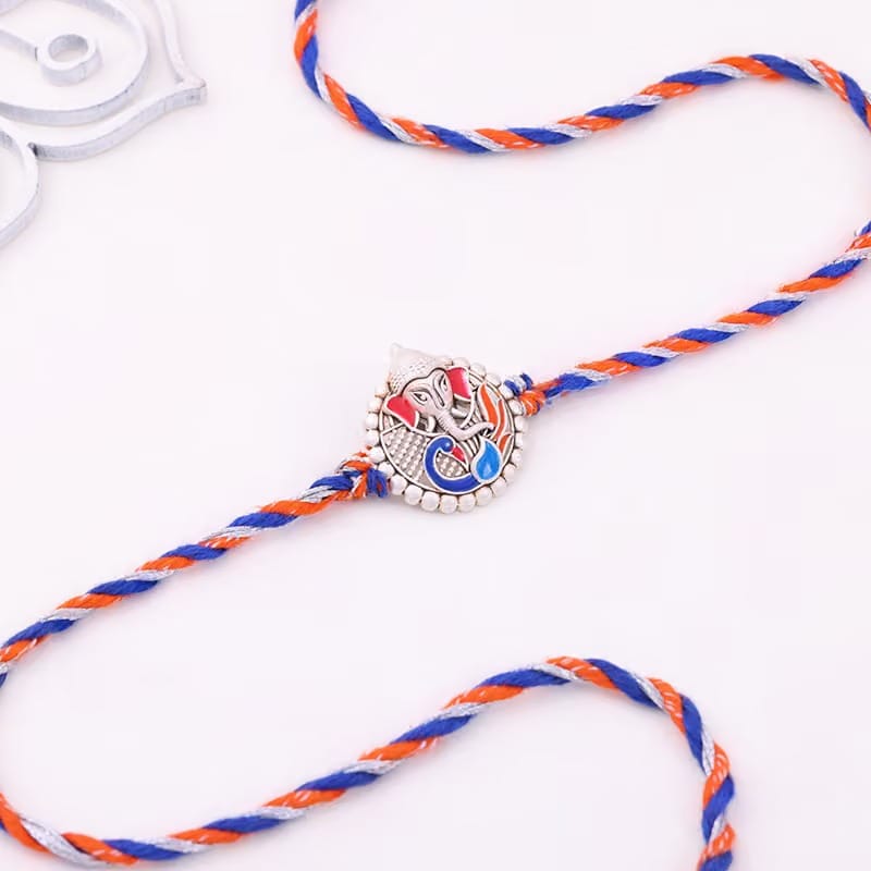 Silver Ganesha Rakhi With Almond Rocks