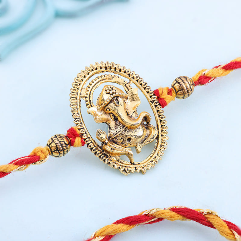 Intricate Golden Ganesha Rakhi