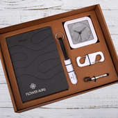 A gift box with a watch, pen, and key chain, employee welcome kit