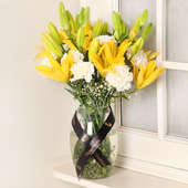 Lily N Carnation Arrangement - Arragnement of 10 White Carnations and 6 Yellow Lilies </li><li> Glass Vase </li>