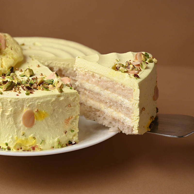 Rasmalai Pista Cream Cake - Sliced View with Knife