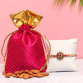 Nut Floral Rakhi Combo - One Metal Rakhi with Complimentary Roli and Chawal and 100gm Almonds in Pink Potli