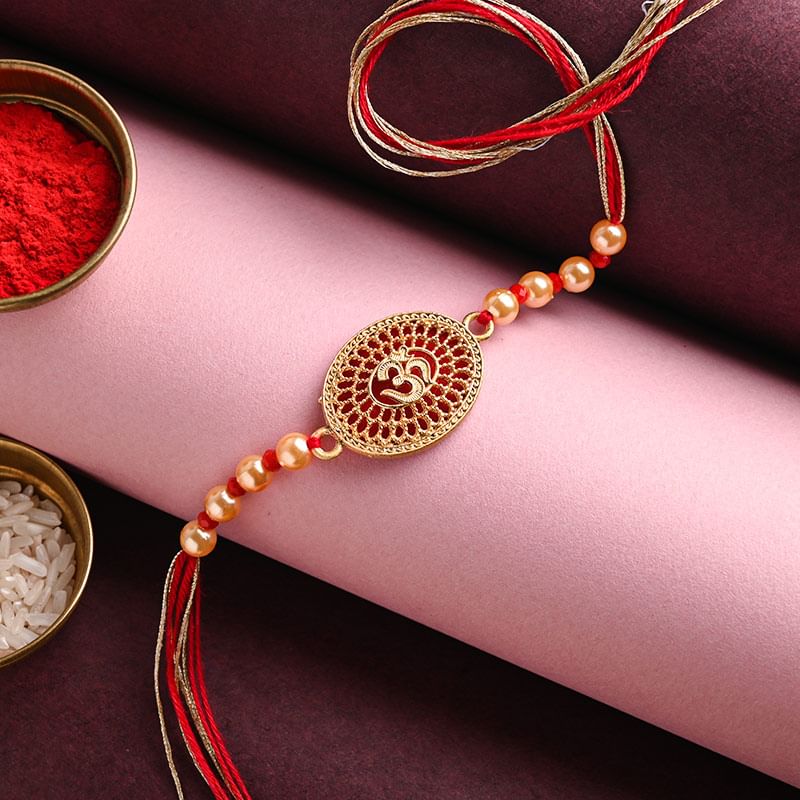 Send Divine rakhi For Brother Online - Om Stone Engraved Pearl Rakhi