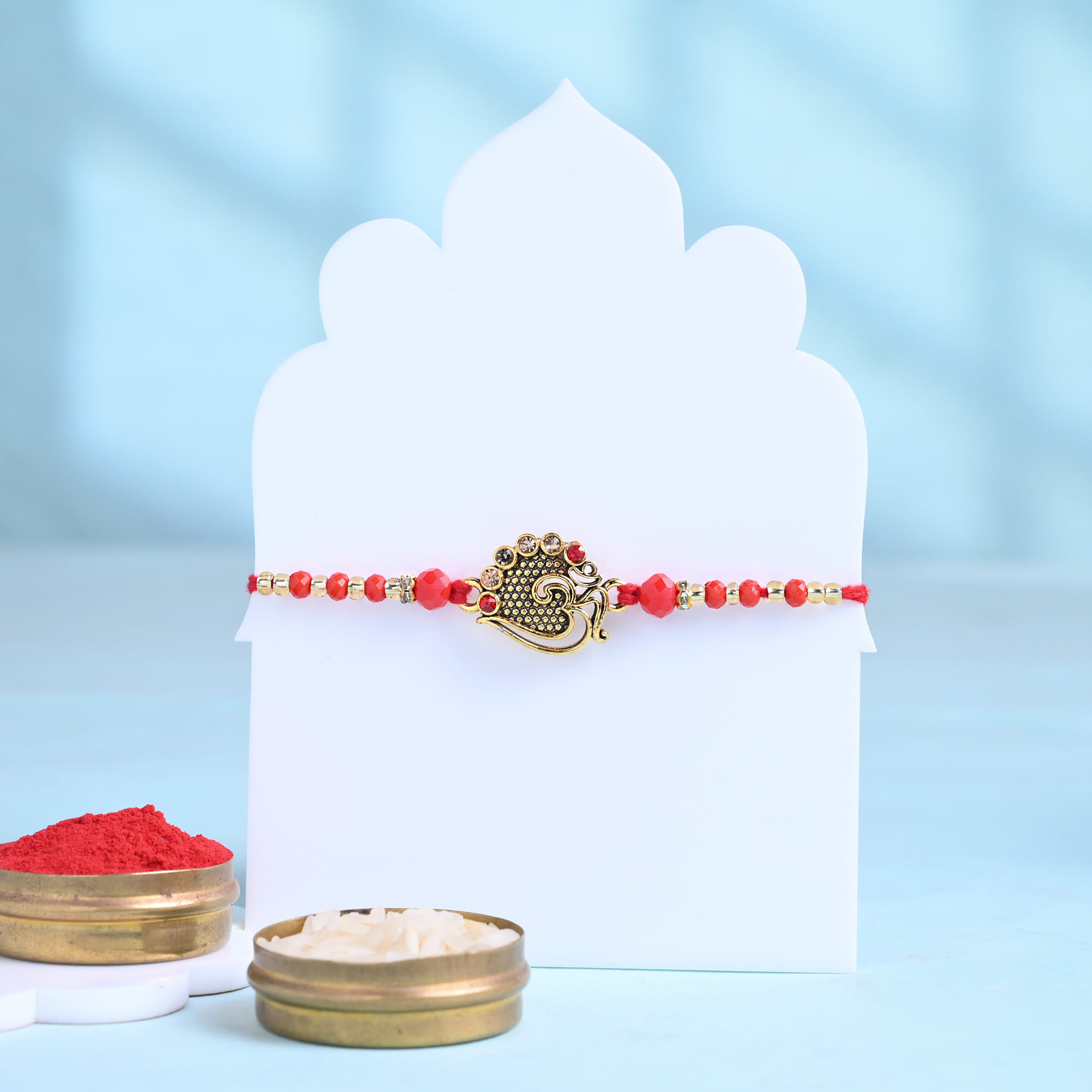 Ornate Om Rakhi With Almond Rocks