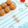 Pastel Charm Rakhi Trio With Besan Laddoo